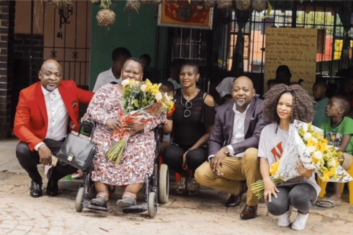Foundation team celebrating with a family receiving support